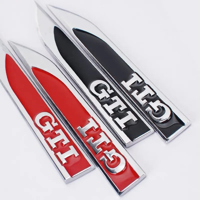 https://cdn.shopify.com/s/files/1/0565/4957/2747/files/Logo-GTI-dailes-avant-pour-VW-Polo-GTI-et-Golf-GTI-Noir-ou-Rouge.webp?v=1761585077
