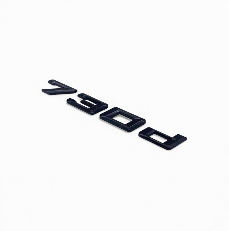 Badges coffre BMW Série 7 noir brillant - vue de face - Becquet Voiture