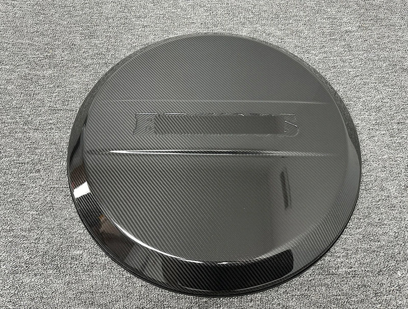 Carbon-Reserveradabdeckung Mercedes G-Klasse W463A W464 2019–2024 - Vorderansicht - Becquet Voiture