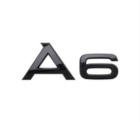 Glossy black Audi A6 trunk emblem - front view - Becquet Voiture