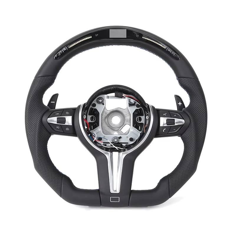 https://cdn.shopify.com/s/files/1/0565/4957/2747/files/volant_bmw_pack_m-forme_performance_-_carbone_haut_bas_-_carbone_centre_-_LED_-_cuir_perfore_-_palettes_-_logo_-_coutures_M-2.jpg?v=1772905313