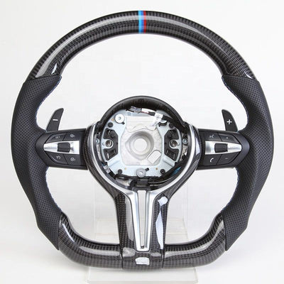 https://cdn.shopify.com/s/files/1/0565/4957/2747/files/volant_bmw_pack_m-forme_performance_-_carbone_haut_bas_-_carbone_centre_-_indice_12h_M_-_cuir_perfore_-_palettes_-_logo_-_coutures_M.jpg?v=1772905313